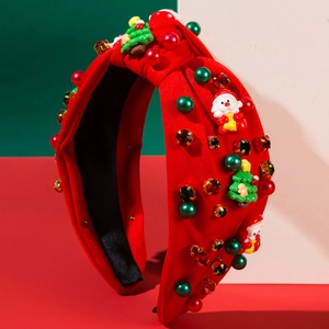 Dettaglio del cerchietto natalizio con Babbo Natale, perle e strass dorati lucidi