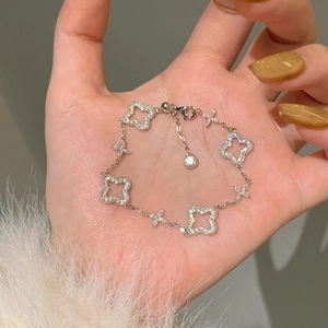 Silver 24K plated bracelet featuring hollow clover charms with sparkling cubic zirconia