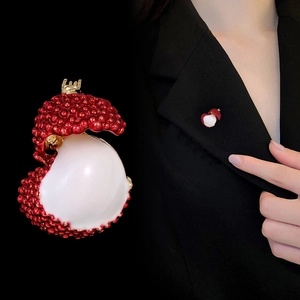Exquisite lychee fruit brooch with red textured shell and white pulp on black suit lapel