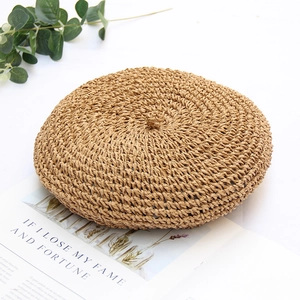 Handmade woven straw beret hat in khaki for summer, shown at a 45-degree top angle