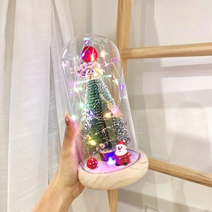 Detailed view of LED light-up Christmas tree glass dome with Santa Claus and bells