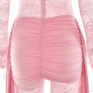 Close-up of pink lace bodysuit featuring ruffled back details and intricate fabric texture