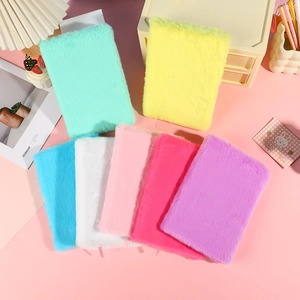 Soft plush cover A5 notebooks in various pastel colors arranged on an aesthetic desk