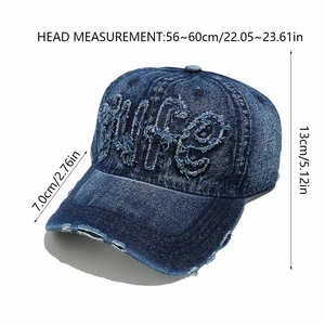 Detail of distressed navy denim cap with Wife embroidery and frayed edges on visor