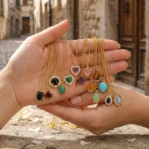 Detailed view of various heart and geometric gemstone pendants on fine gold chains