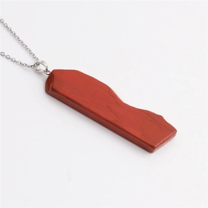 Vue détaillée du pendentif en agate rouge avec bordure plaquée or et chaîne en argent