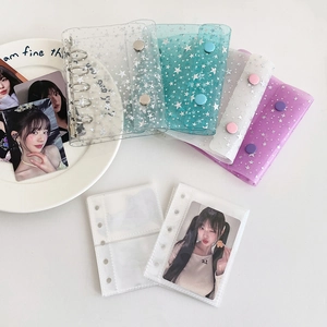 Detail of transparent PVC glitter binder with star patterns and sturdy metal snap closure