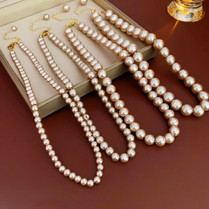 Detail view of four French vintage champagne pearl necklaces in different bead sizes