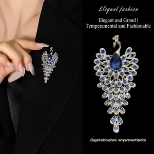Elegant peacock brooch with blue crystal rhinestones on a silver base for women