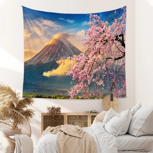 Detailed view of bohemian Mount Fuji tapestry with cherry blossoms hung on bedroom wall