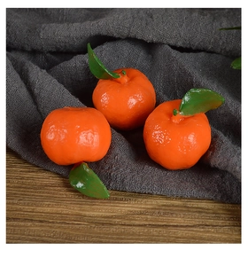 Detailed macro view of realistic PVC mini oranges with green leaves on a rustic background