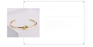 Detailed view of adjustable knot cuff bracelet in gold finish made of 316 stainless steel