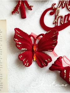 Red velvet Christmas butterfly ornament with gold glitter edges and gemstone detail