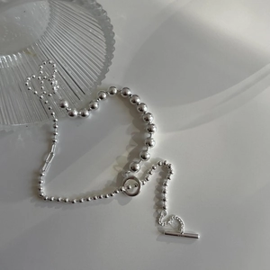 Detailed view of S925 sterling silver beaded necklace featuring a polished OT toggle clasp