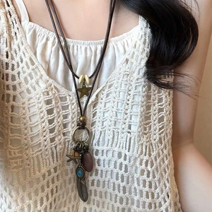 Bohemian leather cord necklace with bronze star, feather charms and blue gemstone