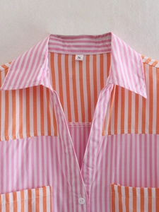Close-up of pink and orange striped shirt collar detail with size S label