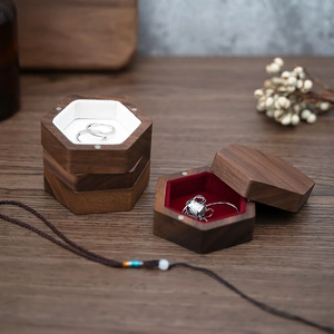 Detailed view of hexagonal walnut wood jewelry boxes with ring and necklace compartments