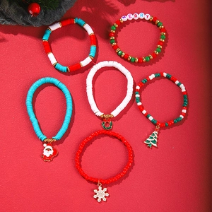 Close-up of a 6-piece Christmas bead bracelet set with Merry charms and festive motifs