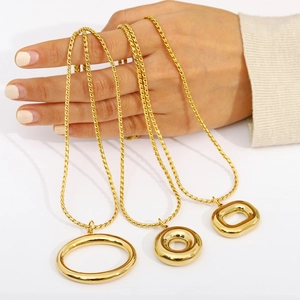Three minimalist 18K gold plated stainless steel necklaces with geometric circle pendants
