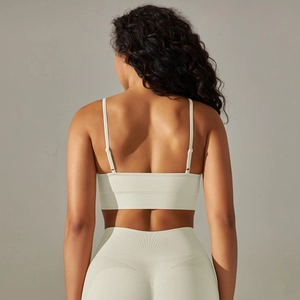 Detail of cross-back straps on seamless ribbed yoga bra and high-waist gym leggings