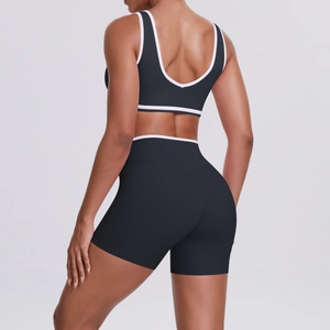 Detail view of two-piece yoga set with contrast white piping and high-waist shorts