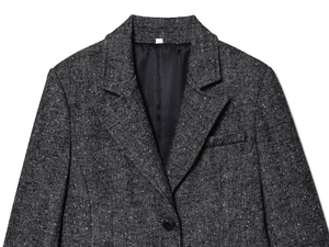 Dettaglio del blazer grigio a spina di pesce che mostra il bavero e la trama del tessuto