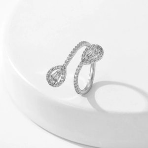 Detailed view of pear-cut zircon stones on an adjustable silver open ring band