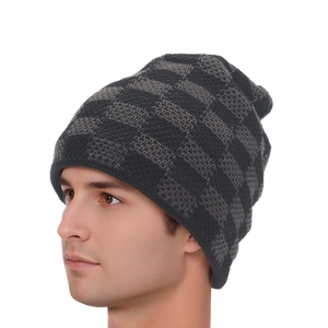 Detail of grey checkerboard knit beanie showing texture and fit on a male model