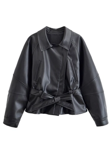 Detail of a black leather jacket featuring a notched lapel and a tied waist belt