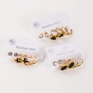 Three-pair stainless steel earring set with black enamel heart, butterfly, and palm charms