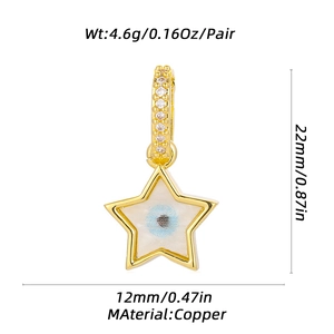 Detail view of gold star earrings with blue evil eye enamel, 22mm copper jewelry