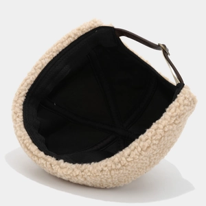 Beige Sherpa brimless cap with brown leather strap and metal buckle adjustment