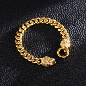 Macro shot of gold-plated lion head clasp and heavy cuban link chain for men