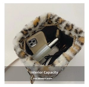 Macro view of leopard print plush bucket bag showing spacious interior with mobile and cosmetics
