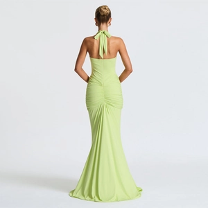 Detail view of lime green halter neck dress with ruched back and mermaid fishtail hemline