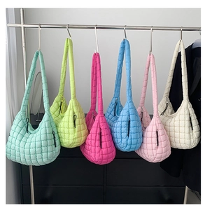Row of colorful quilted cloud tote bags showing square puff texture and wide straps