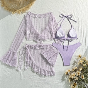 Flat lay of lavender lace cover-up and ruffled skirt with ribbed bikini set and straw hat