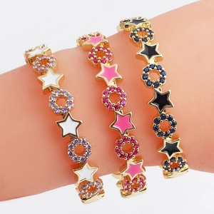 Detailed view of colorful enamel star bracelets with sparkling zircon stones in gold finish