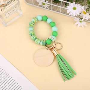 Silicone bead keychain bracelet in green tones with wooden tag and leather tassel