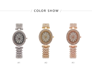 Three elegant crystal-encrusted watches in silver, gold, and rose gold with flower dials