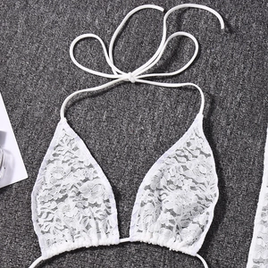 Detailed close-up of white lace halter bikini top with delicate floral textures