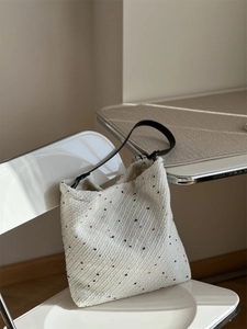Macro detail of thick twill woven fabric with colorful dots on a tote shoulder bag
