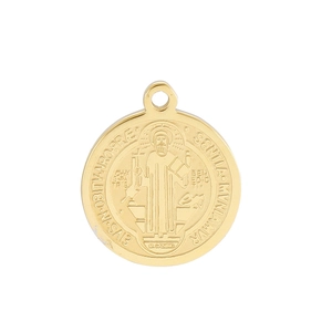 Close-up of golden Saint Benedict medal pendant with detailed religious relief and latin text