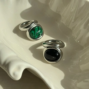 Detail of 18k gold plated vintage rings with green malachite and black agate stones