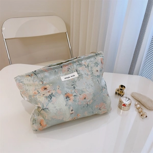 Detail of floral canvas cosmetic bag with simple wish label and vintage patterns