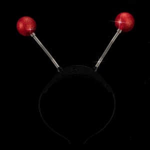 Detail of red sequin alien antenna headband with silver spring and power switch