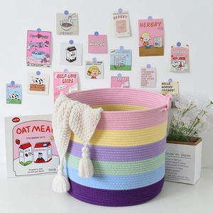 Detailed macro view of a rainbow cotton rope storage basket with white tassels decoration