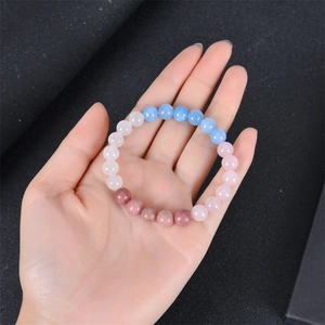 Aquamarine and mahogany stone fertility beaded bracelet for women on a dark background