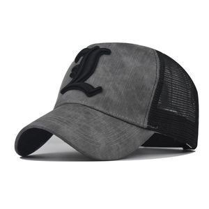 Detail of grey vintage fabric and black mesh on a baseball cap with gothic L embroidery