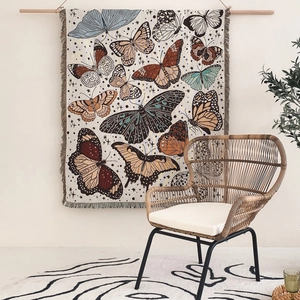 Bohemian woven cotton blanket featuring colorful butterfly patterns with tassel edges